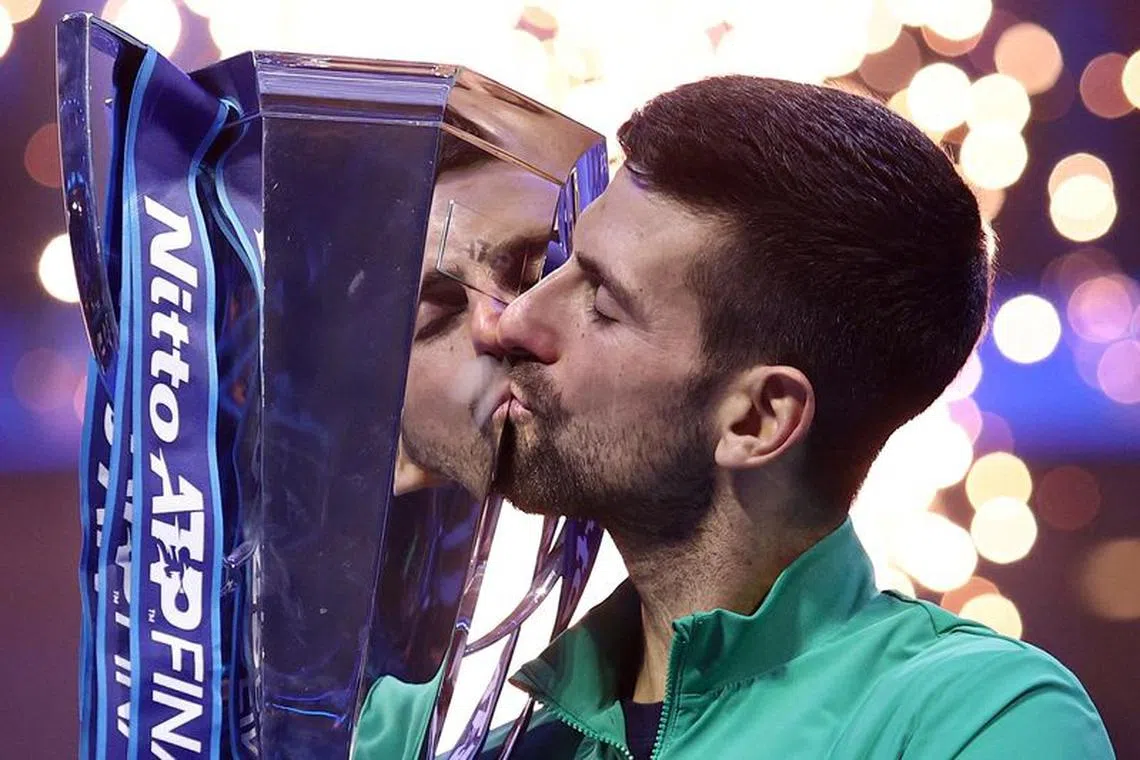 Tennis - ATP Finals - Pala Alpitour, Turin, Italy - November 19, 2023  Serbia's Novak Djokovic celebrates with a trophy after winning the final against Italy's Jannik Sinner REUTERS/Guglielmo Mangiapane     TPX IMAGES OF THE DAY