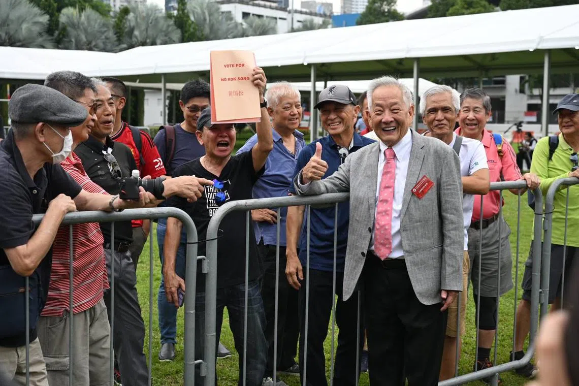 Ng Kok Song posing for a photo with his supporters. 