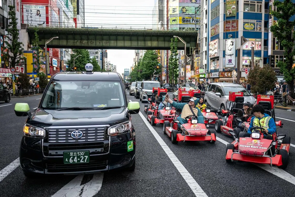 Go-karting is a popular sight in Japan, with tourists dressing up as Super Mario and other characters.