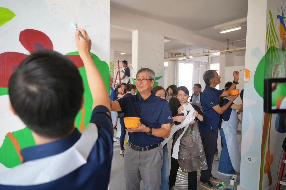 Temasek Holdings chairman Lim Boon Heng (left) and CEO Dilhan Pillay painting murals during the annual Community Day, on June 25.