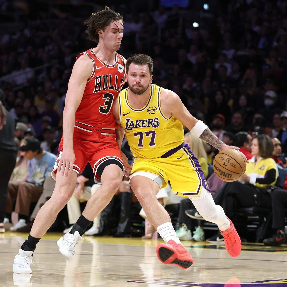 LOS ANGELES, CALIFORNIA - MARCH 12: 


Luka Doncic #77 of the Los Angeles Lakers dribbles into the defense of Josh Giddey #3 of the Chicago Bulls during the first half of a game at Crypto.com Arena on March 12, 2026 in Los Angeles, California.   Sean M. Haffey/Getty Images/AFP (Photo by Sean M. Haffey / GETTY IMAGES NORTH AMERICA / Getty Images via AFP)