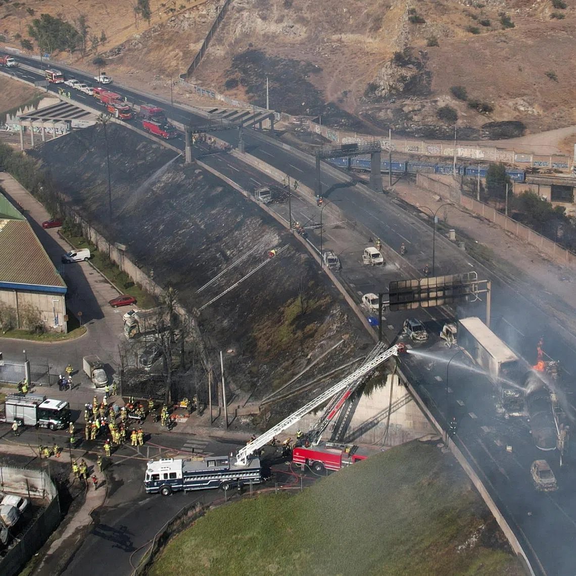 A drone view shows firefighters working at the site of a deadly explosion, according to local media, in Santiago, Chile, February 19, 2026. REUTERS/Pablo Sanhueza        TPX IMAGES OF THE DAY