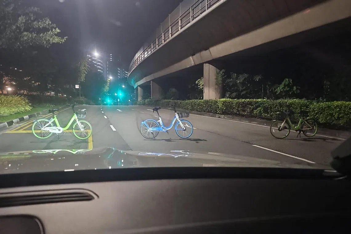  Each bicycle is parked on a lane of the three-lane road.