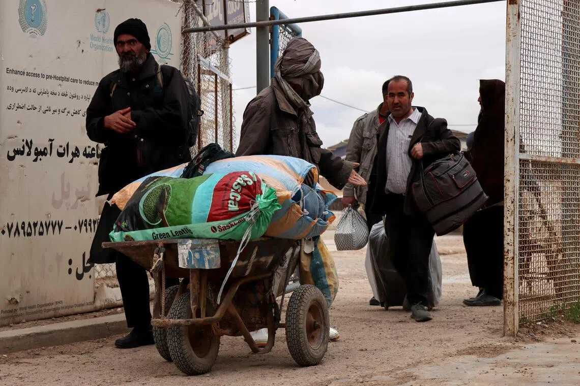 Afghan nationals arrive at the Islam Qala border crossing between Afghanistan and Iran in Herat province on March 10.