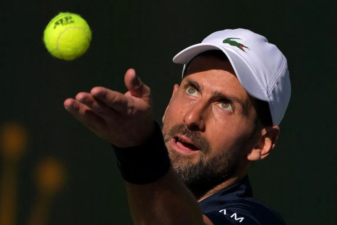 Mar 7, 2026; Indian Wells, CA, USA;  Novak Djokovic (SRB) tosses the ball for a serve during his second round match against Kamil Majchrzak (POL) in the BNP Paribas Open at the Indian Wells Tennis Garden. Mandatory Credit: Jayne Kamin-Oncea-Imagn Images