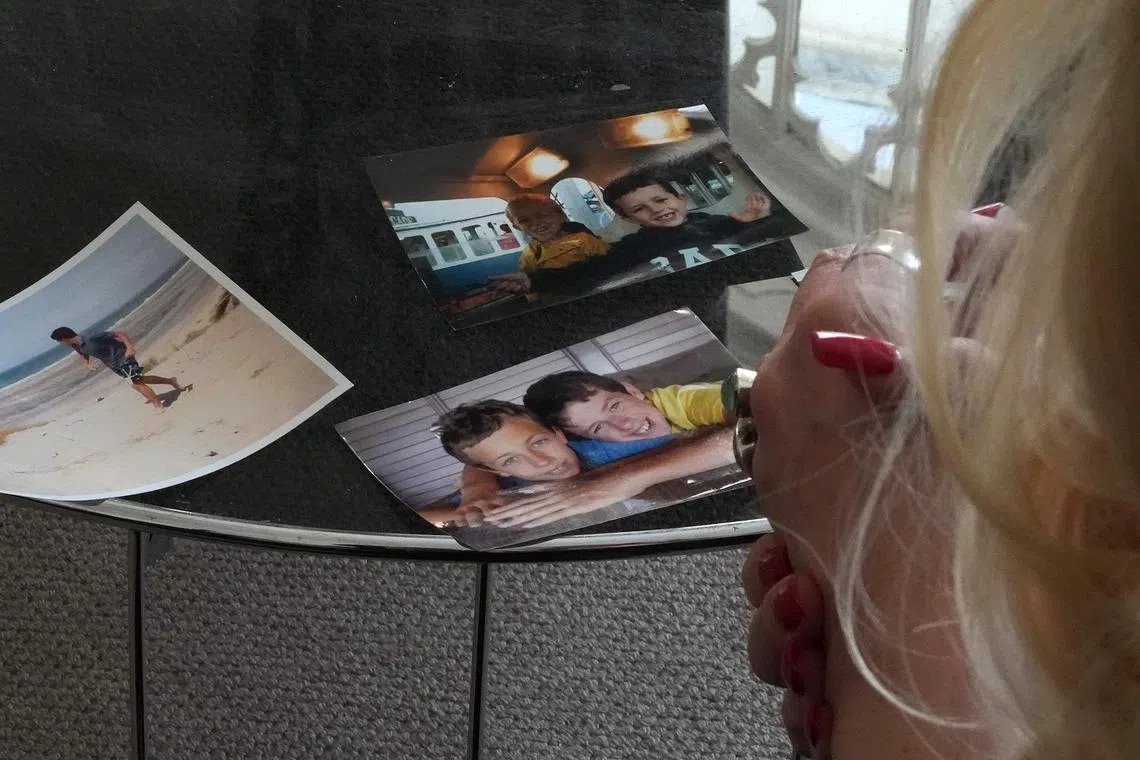 Ms Deborah Casserly looking at pictures of her late son Barney Casserly, who died in April 2018.