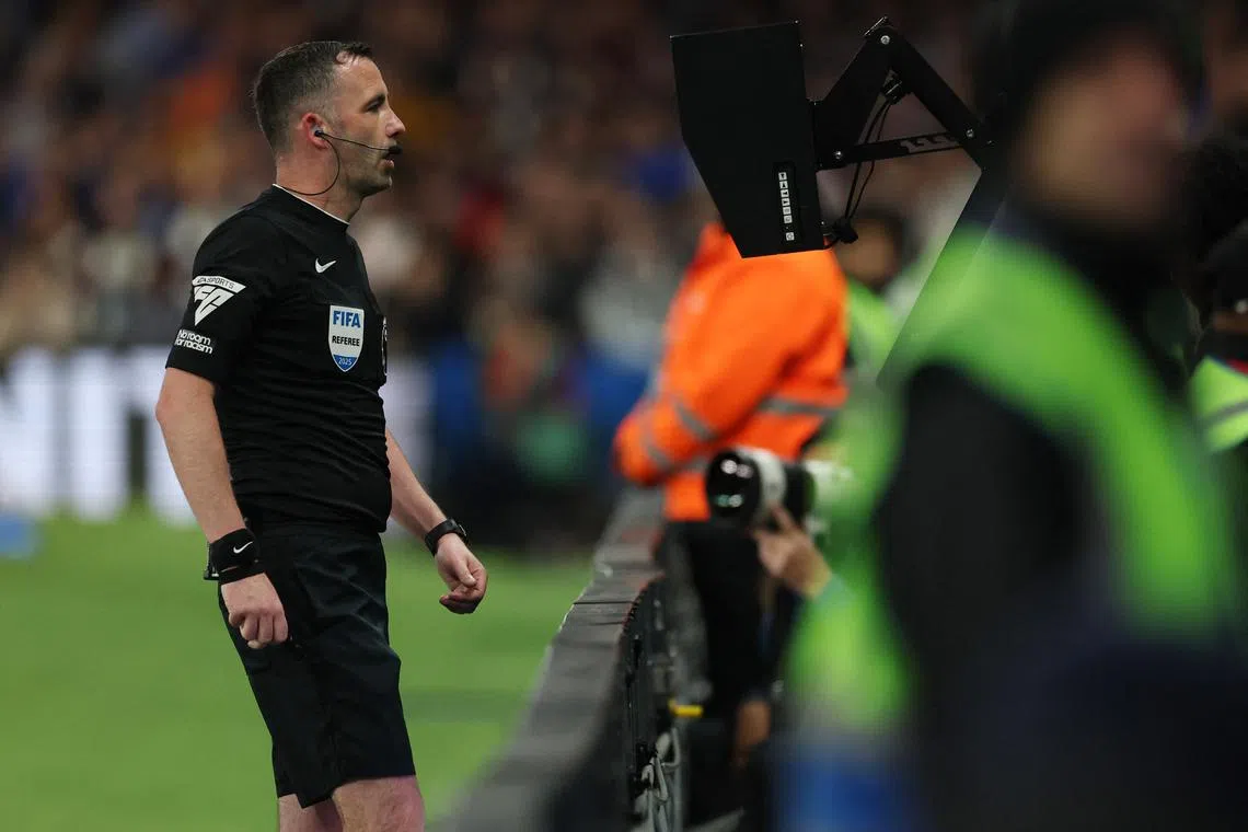 FILE PHOTO: Soccer Football - Premier League - Chelsea v Manchester United - Stamford Bridge, London, Britain - May 16, 2025 Referee Chris Kavanagh looks at a VAR screen REUTERS/Hannah Mckay/File Photo