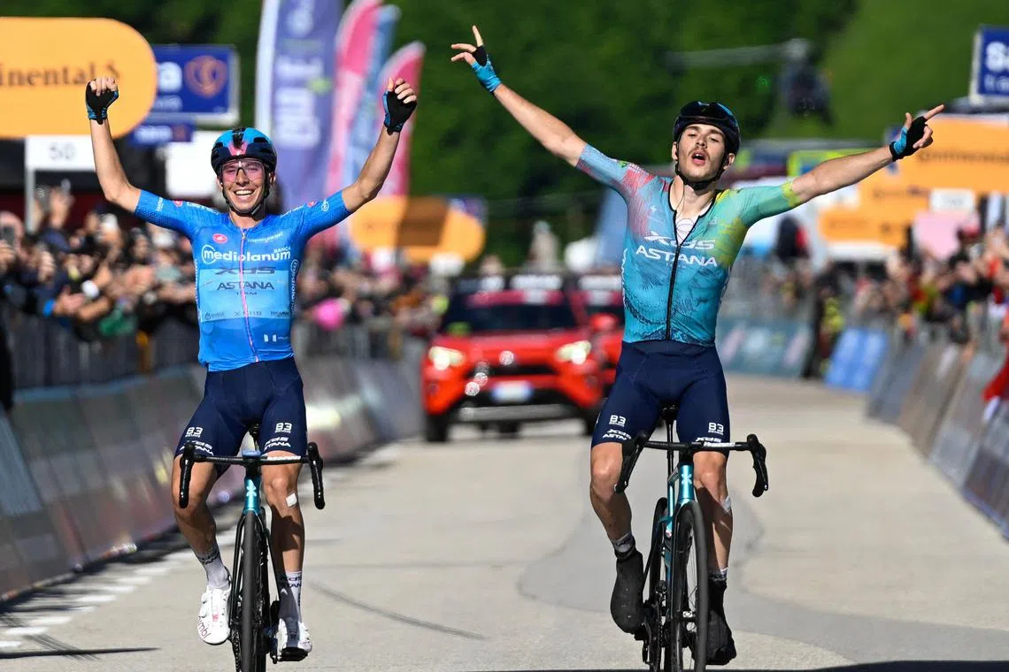 XDS Astana Team rider Christian Scaroni (right) celebrating at the end of the 16th stage on May 27, alongside second-placed XDS Astana rider Lorenzo Fortunato.
