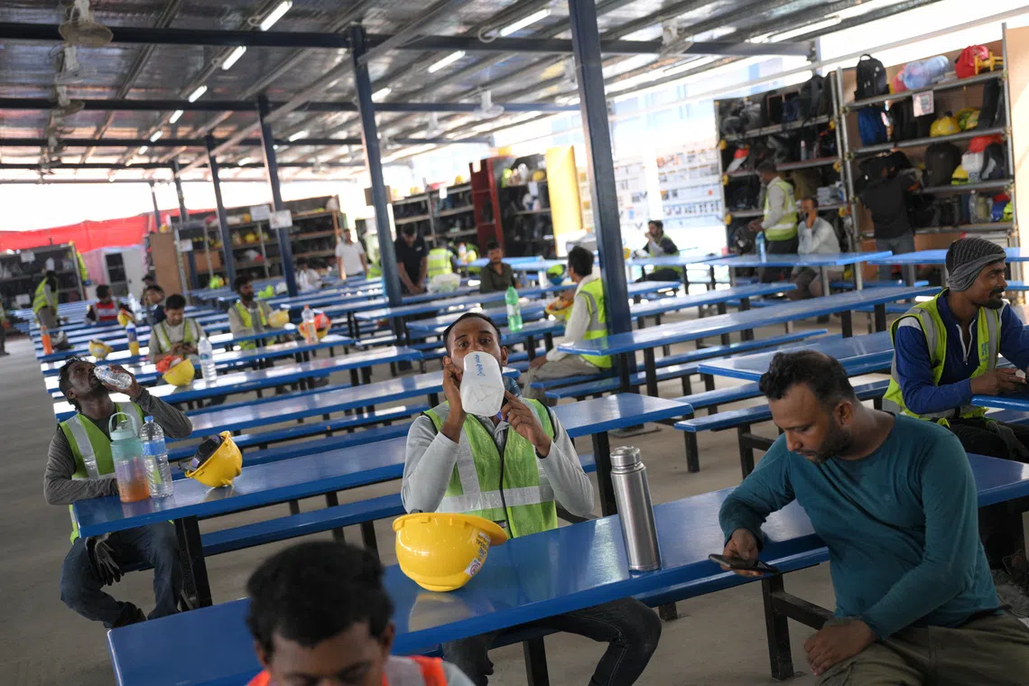 Workers at a sheltered area with insulated roofing at the construction site of the PSA Supply Chain Hub @ Tuas, during a showcase of how heat stress risks are managed.