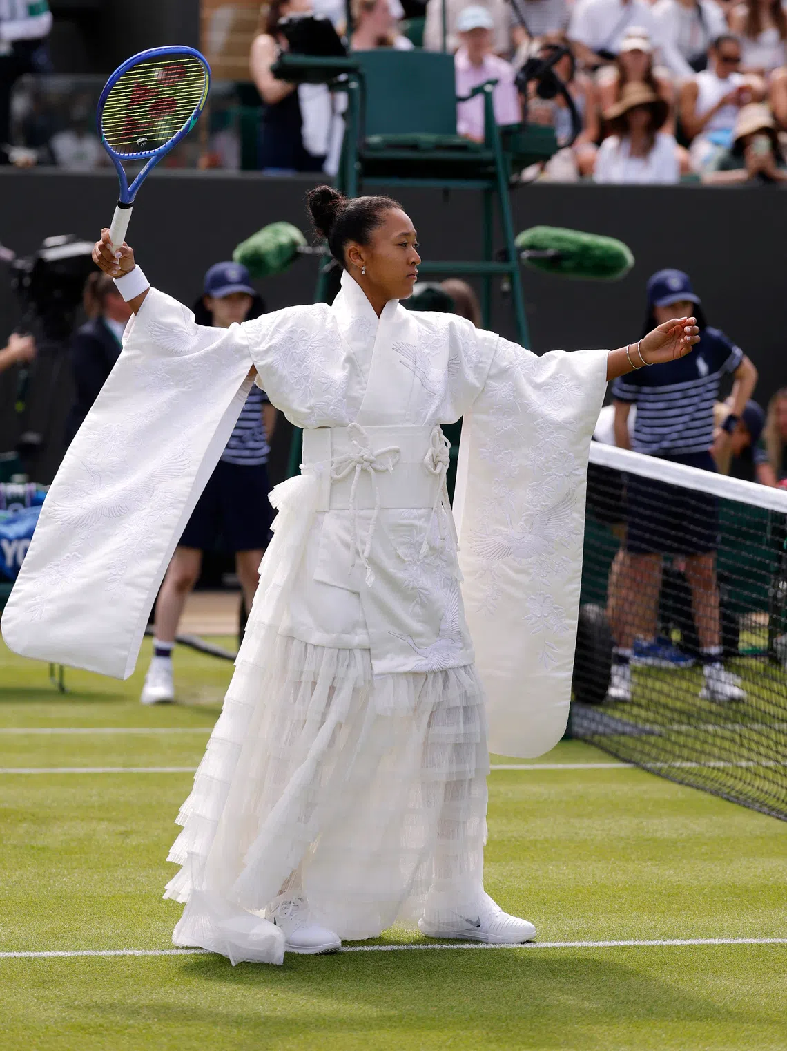 At Wimbledon, Naomi Osaka paid tribute to her Japanese heritage with a kimono-inspired ensemble featuring a traditional kanzashi hair ornament before changing into a white Nike playing kit.
