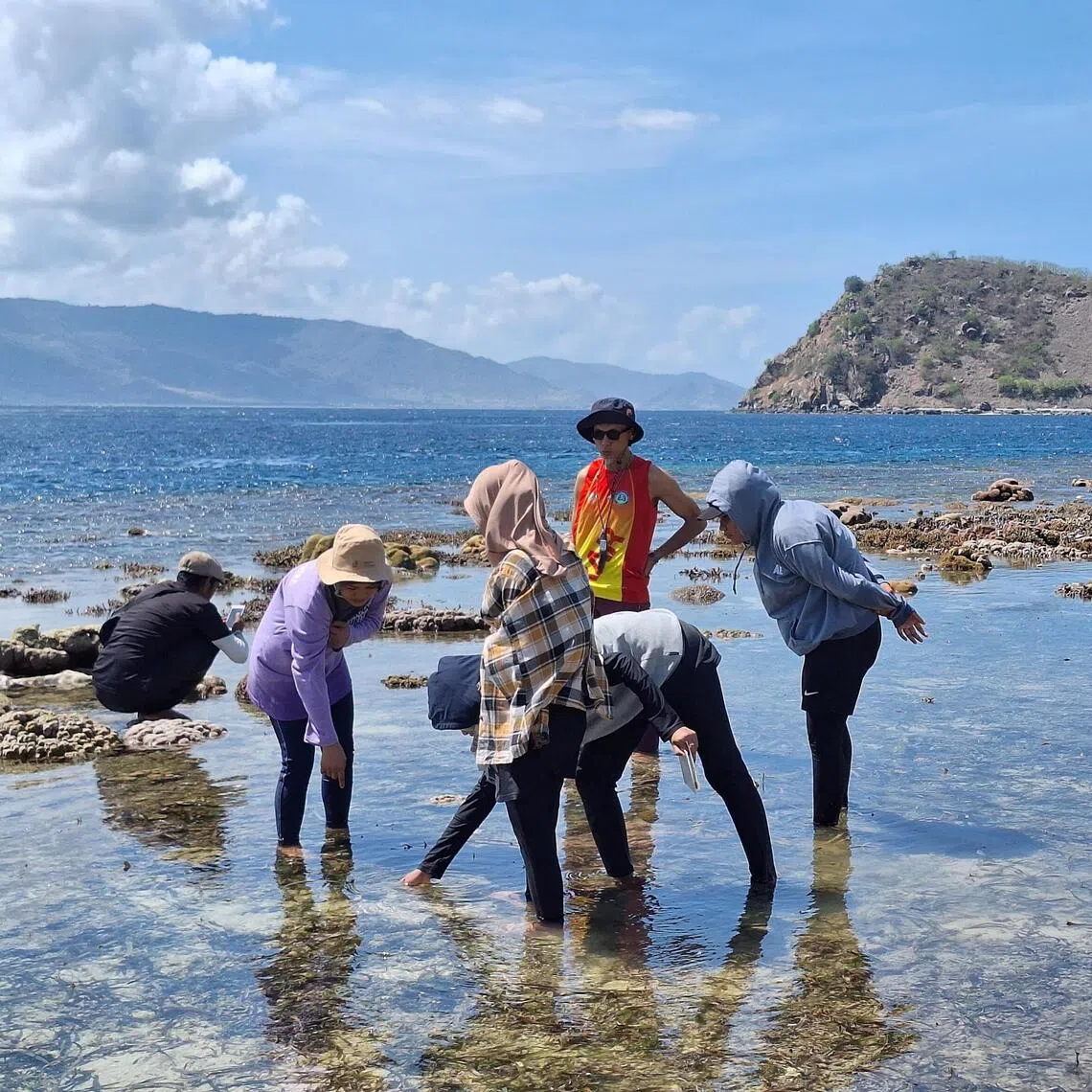 Fishermen learning from volunteers how to monitor the health of corals at Gili Balu marine park in Indonesia. 