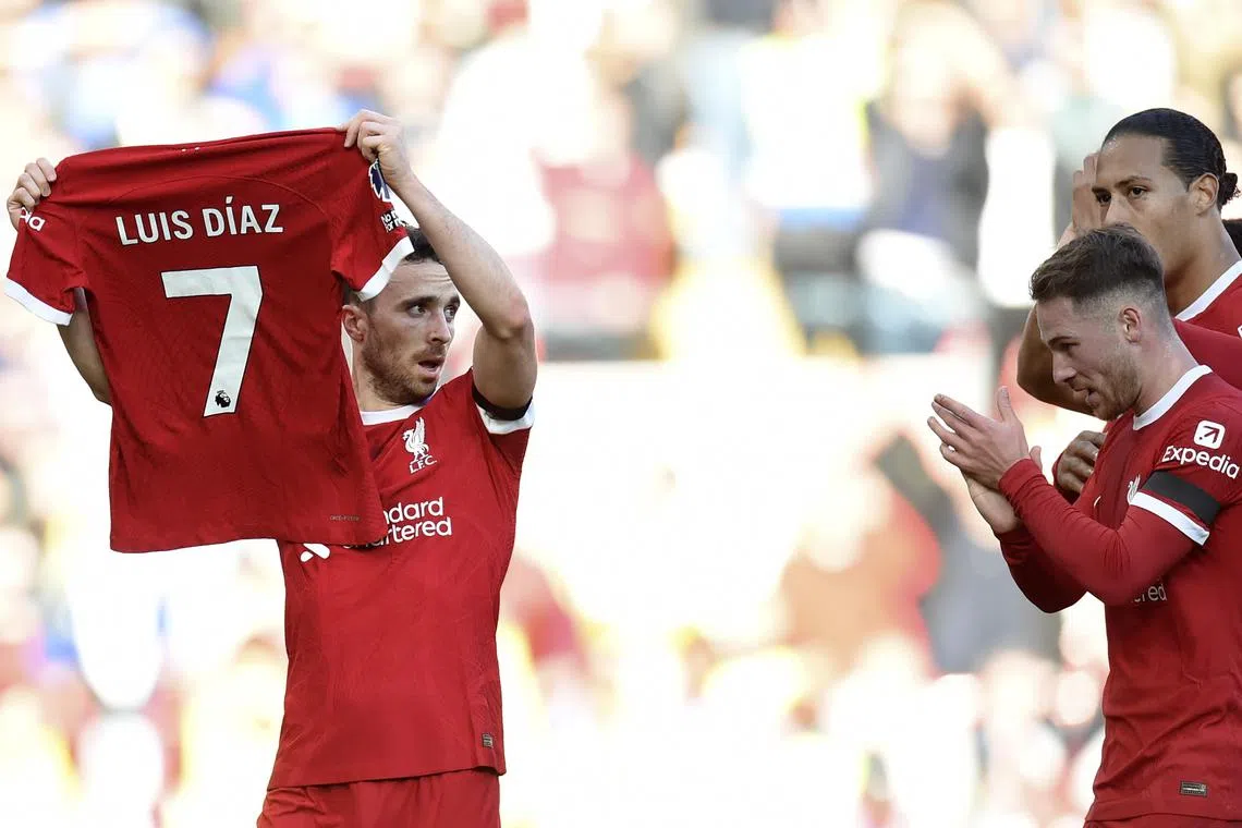 Diogo Jota of Liverpool celebrates scoring the opener in the 3-0 win over Nottingham Forest at Anfield on Sunday by holding up the jersey of teammate Luis Diaz, whose parents were kidnapped in Colombia.