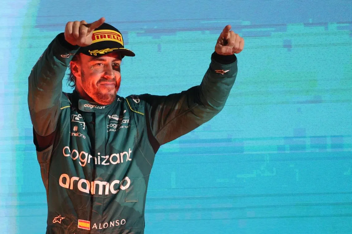Aston Martin driver Fernando Alonso celebrating on the podium after the Bahrain Grand Prix at the Bahrain International Circuit in Sakhir.