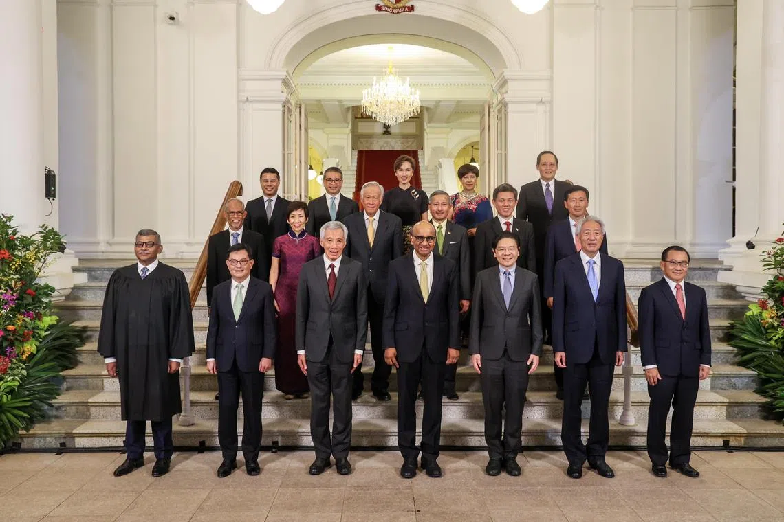 President Tharman Shanmugaratnam with PM Lee Hsien Loong (front, third left), Chief Justice Sundaresh Menon (front, left), Speaker of the House Seah Kian Peng (front, right) and members of the Cabinet at the Istana on Sept 14.