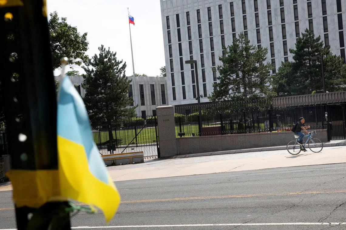 FILE PHOTO: A pedestrian rides a bicycle outside the Russian Embassy in the Glover Park neighborhood in Washington, U.S., July 5, 2022. REUTERS/Tom Brenner/File Photo