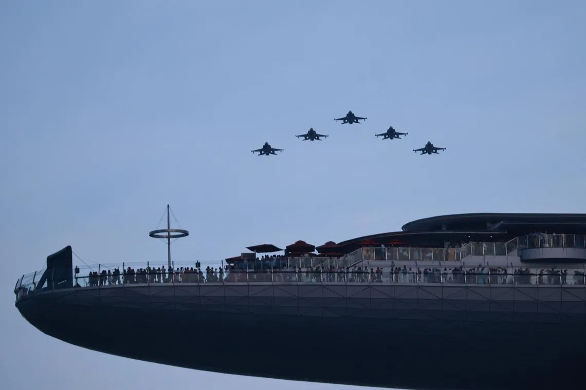 F-15SG fighter aircraft flying over Marina Bay as part of the National Day celebrations on Aug 9, 2023. ST PHOTO: JASON QUAH