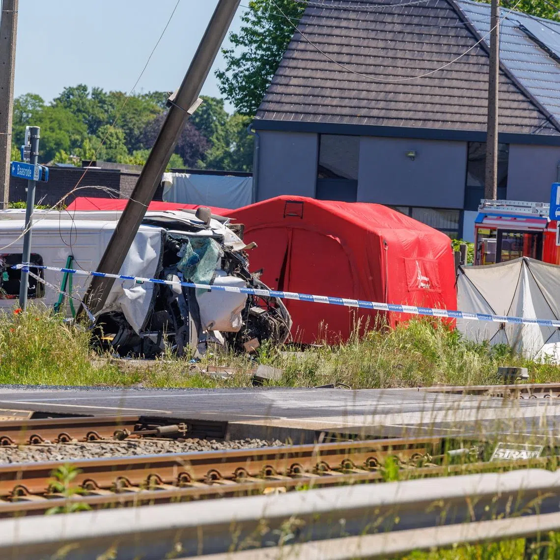 Images from the scene in the Flanders region showed a badly damaged minibus lying on its side on a road next to a railway line.