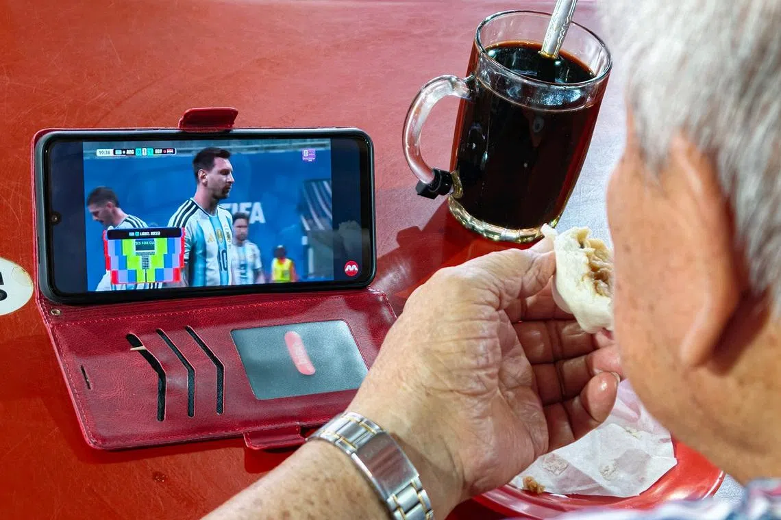 (Pls note: For pixdesk HIF, only used for that purpose) An elderly diner watching the highlights of the FIFA World Cup 2026 Round of 16 match between Argentina and Egypt at West Coast Market and Food Centre on July 8, 2026. ST PHOTO: BRIAN TEO