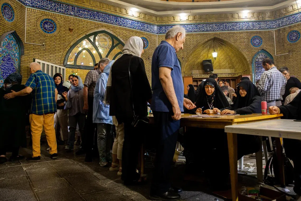 People arrive to cast their ballots at a polling place set up inside a mosque in Tehran, Iran on Friday, June 28, 2024. After a testy campaign that featured strong attacks on the government by virtually all the candidates over the economy, internet restrictions and harsh enforcement of the hijab law on women, Iran is  holding elections on Friday to pick a president. (Arash Khamooshi/The New York Times)
