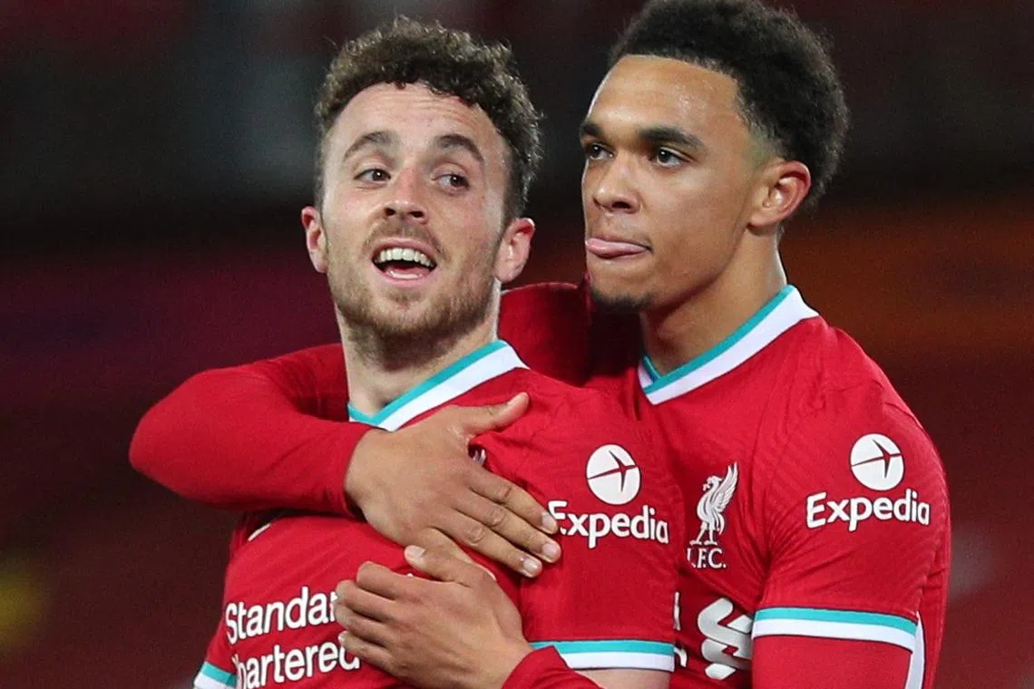 FILE PHOTO: Soccer Football - Premier League - Liverpool v Sheffield United - Anfield, Liverpool, Britain - October 24, 2020 Liverpool's Diogo Jota celebrates scoring their second goal with Trent Alexander-Arnold Pool via REUTERS/Peter Byrne/File Photo