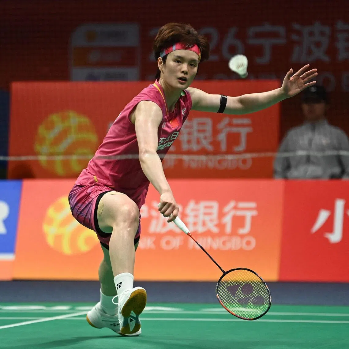 China's Wang Zhiyi hits a return to Japan's Akane Yamaguchi during their women's singles semifinal match at the Badminton Asia Championship in Ningbo, eastern China's Zhejiang province on April 11, 2026. (Photo by CN-STR / AFP) / China OUT