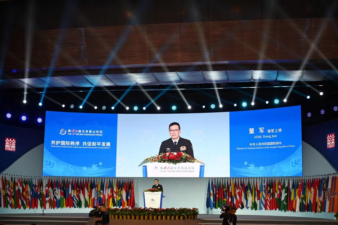 TOPSHOT - China's Defence Minister Dong Jun speaks at the opening ceremony of the Xiangshan Forum at the Beijing International Convention Center in Beijing on September 18, 2025. (Photo by GREG BAKER / AFP)
