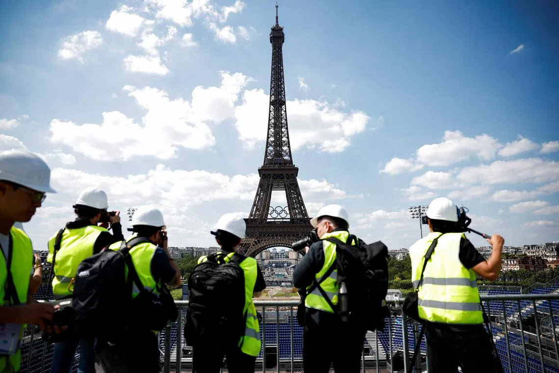 FILE PHOTO: Journalists visit the Eiffel Tower Stadium venue where beach volleyball events will be held during the Paris 2024 Olympic Games, at the foot of the Eiffel Tower in Paris, France, June 25, 2024. REUTERS/Benoit Tessier/File Photo