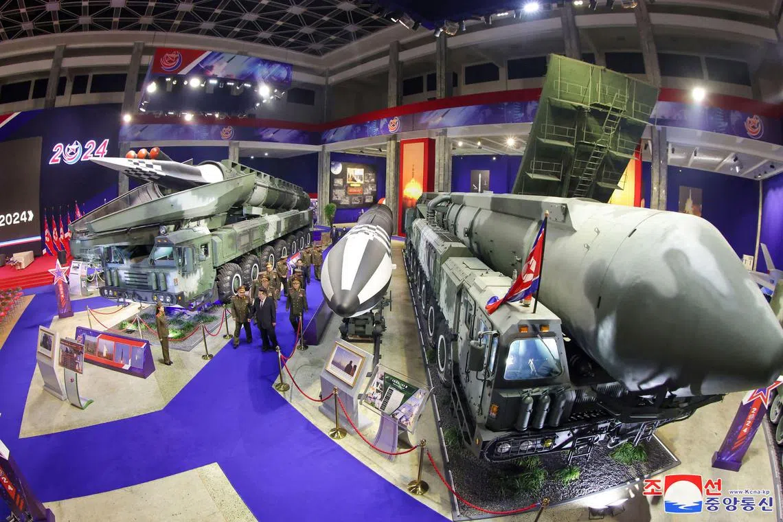 This picture taken on November 21, 2024 and released from North Korea's official Korean Central News Agency (KCNA) on November 22, 2024 shows North Korean leader Kim Jong Un (front C) walking past weaponry on display during the National Defence Development-2024 exhibition in Pyongyang. (Photo by KCNA VIA KNS / AFP) / South Korea OUT / ---EDITORS NOTE--- RESTRICTED TO EDITORIAL USE - MANDATORY CREDIT "AFP PHOTO/KCNA VIA KNS" - NO MARKETING NO ADVERTISING CAMPAIGNS - DISTRIBUTED AS A SERVICE TO CLIENTS / THIS PICTURE WAS MADE AVAILABLE BY A THIRD PARTY. AFP CAN NOT INDEPENDENTLY VERIFY THE AUTHENTICITY, LOCATION, DATE AND CONTENT OF THIS IMAGE --- / 