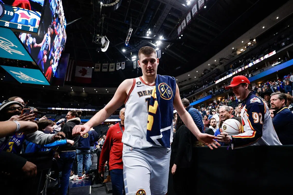 Denver Nuggets centre Nikola Jokic greets fans as he walks off the court after the game against the Charlotte Hornets at Ball Arena.