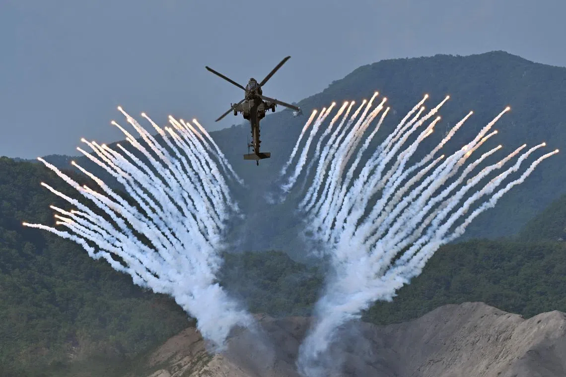 a South Korean Apache helicopter fires flares during a joint military drill  in Pocheon.