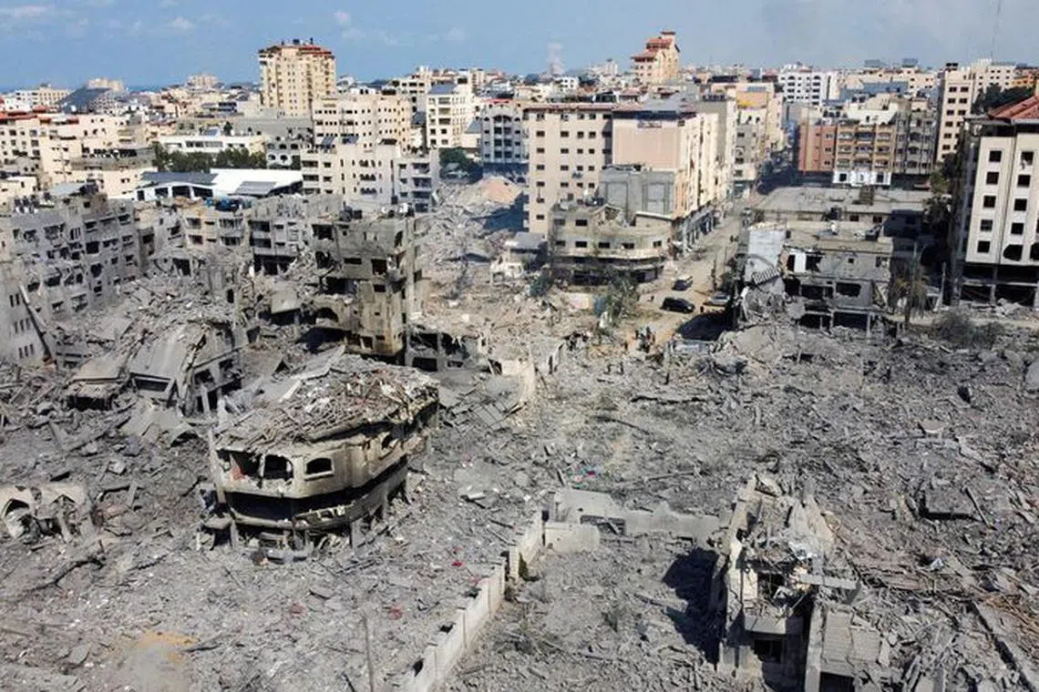 FILE PHOTO: A view shows houses and buildings destroyed by Israeli strikes in Gaza City, October 10, 2023. REUTERS/Mohammed Salem/File Photo