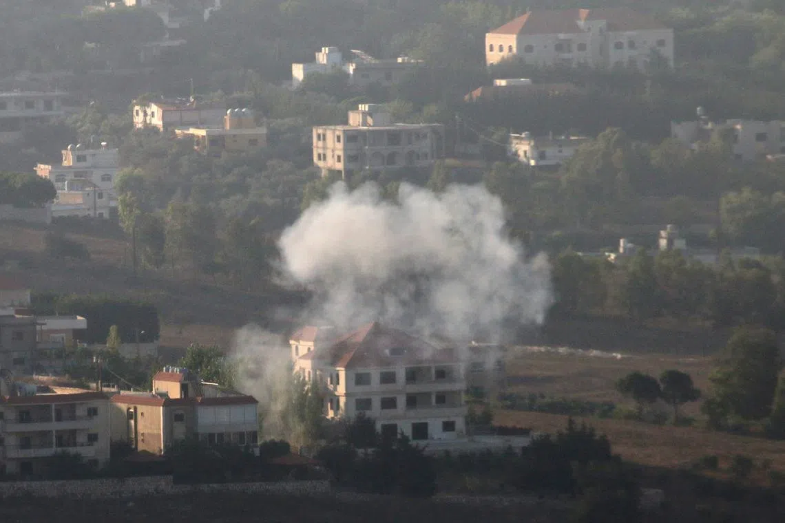 Smoke rises from the southern Lebanese town of Khiam, amid ongoing cross-border hostilities between Hezbollah and Israeli forces, as pictured from Marjayoun, near the border with Israel, August 25, 2024. REUTERS/Karamallah Daher