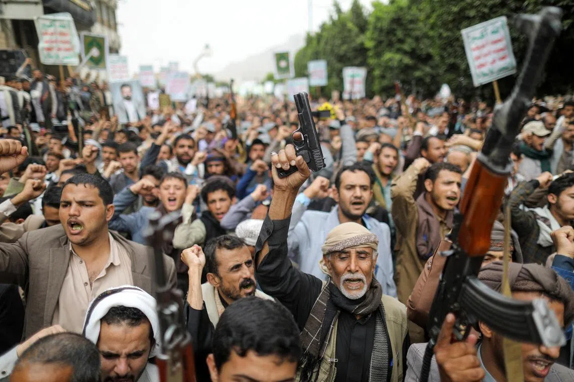 Men hold firearms as people demonstrate against the desecration of the Koran in Denmark.