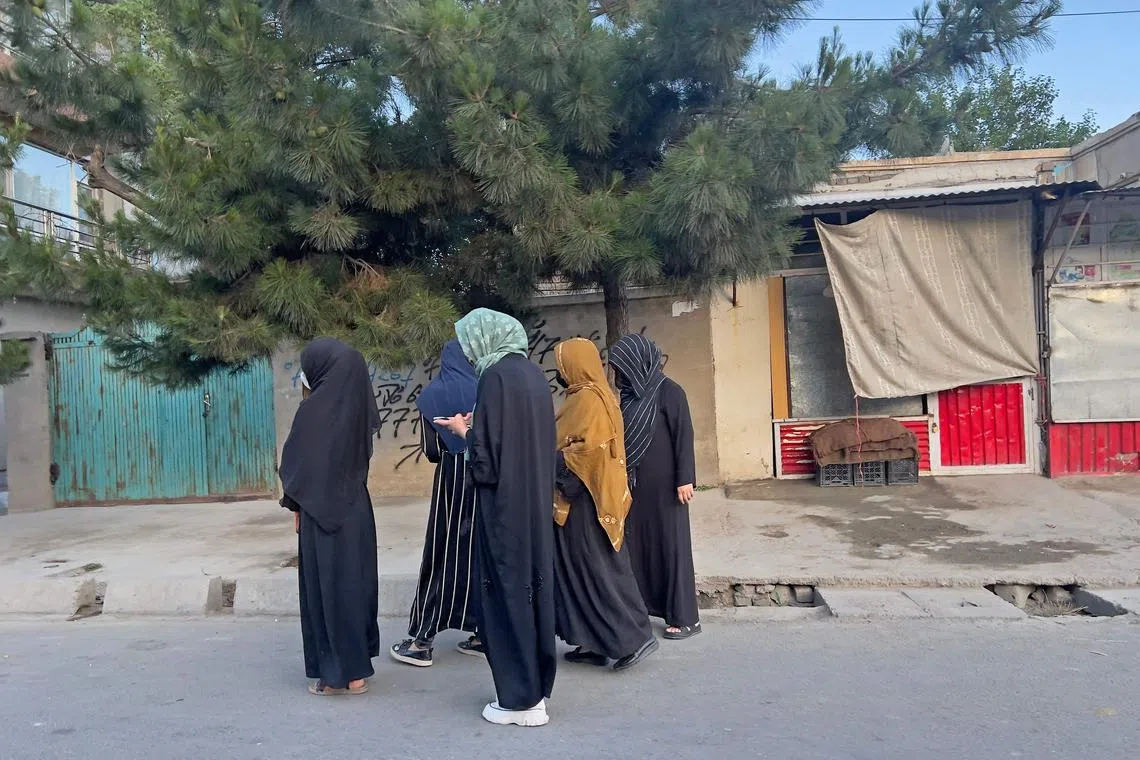 In this photograph taken on June 26, 2024, Afghan women walk along a road during early morning in Kabul. (Photo by AFP) / To go with 'Afghanistan-Women-Rights-Exercise-Sport-Oly', REPORTAGE