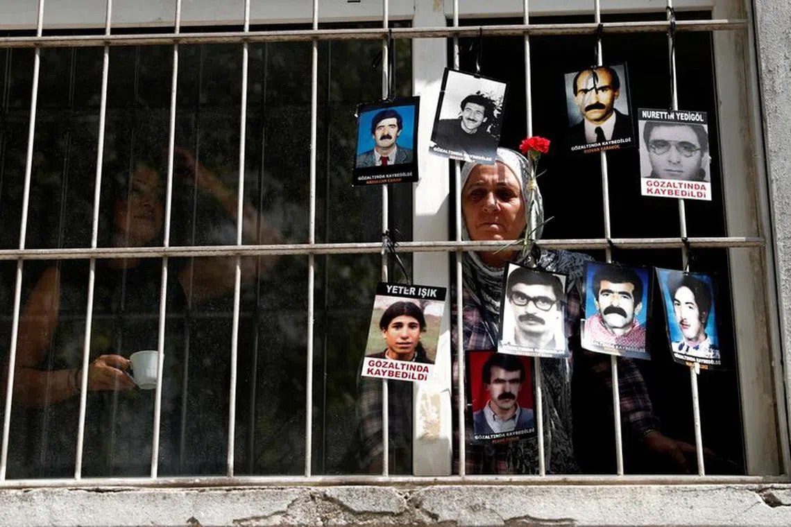 FILE PHOTO: A member of the Saturday Mothers looks out of the window of Human Rights Association after they were prevented by the security forces to march to Galatasaray Square, where they hold a vigil every week, sitting in silence and holding pictures of relatives who went missing in police detention, in Istanbul, Turkey September 8, 2018. REUTERS/Murad Sezer