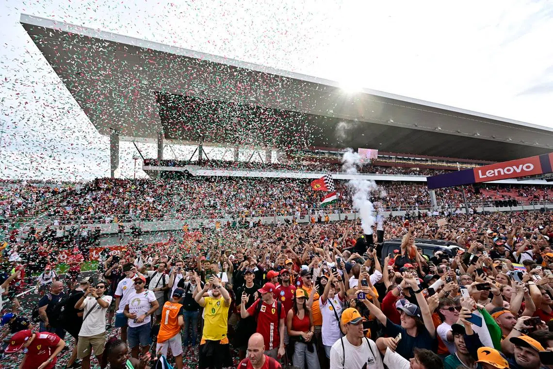Formula One F1 - Hungarian Grand Prix - Hungaroring, Budapest, Hungary - August 3, 2025 Spectators on the track after McLaren's Lando Norris won the Hungarian Grand Prix REUTERS/Marton Monus