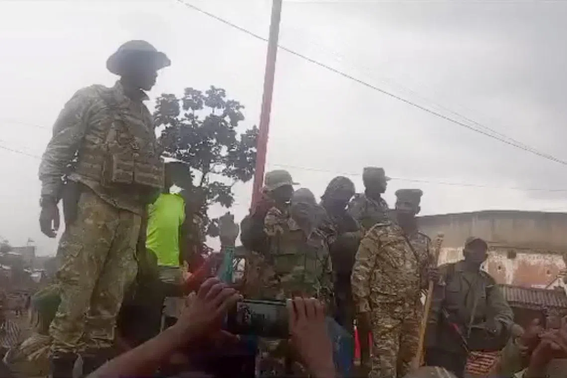 People in military clothing are seen in Katana, near Kavumu airport, Democratic Republic of Congo, in this still image obtained from a social media video released on Feb 14, 2025.