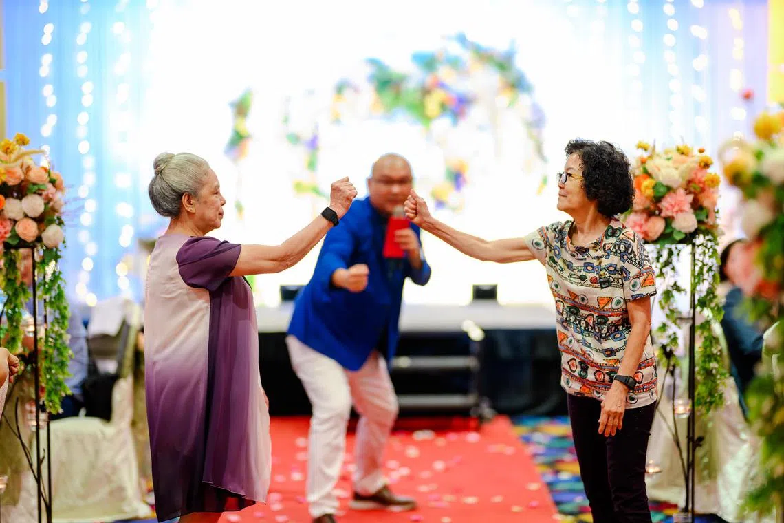 Two guests were engaged in a game of scissors-paper-stone to win the prize of a Toto ticket at the wedding of Ms Emjay Kong and Mr Nixon Tan.
