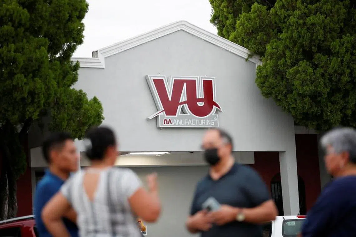 FILE PHOTO: Members of the Liga Obrera Sindical Mexicana (Mexican Workers Union League) talk outside the VU Manufacturing auto parts plant in Piedras Negras, Mexico, August 31, 2022. REUTERS/Daniel Becerril/File Photo