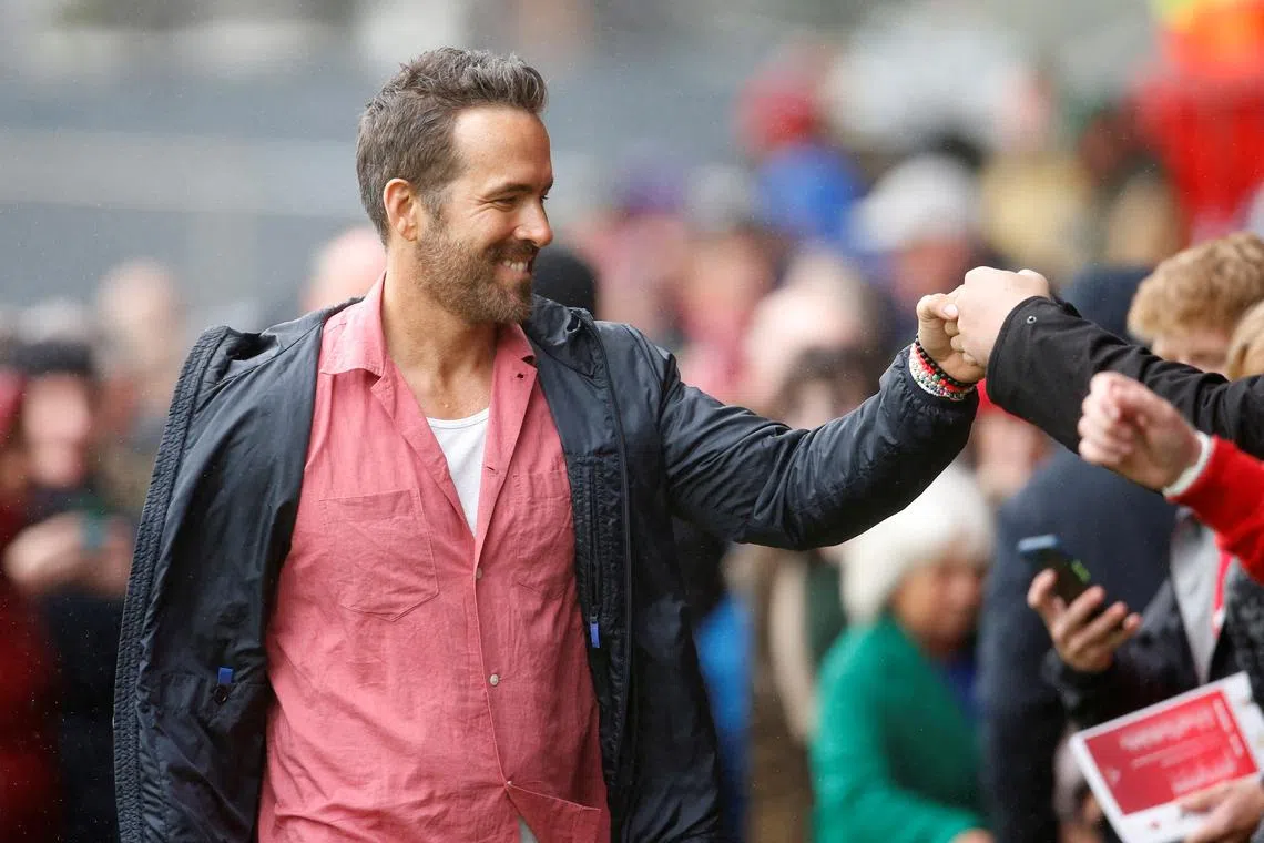 FILE PHOTO: Soccer Football - England - League Two - Wrexham v Milton Keynes Dons - Racecourse Ground, Wrexham, Britain - August 5, 2023 Wrexham co-owner Ryan Reynolds with fans before the match Action Images via Reuters/Ed Sykes/File Photo