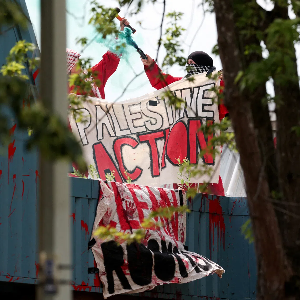 Protesters from \"Palestine Action\" demonstrate on the roof of Guardtech Group in Brandon, Suffolk, Britain, July 1, 2025. REUTERS/Chris Radburn