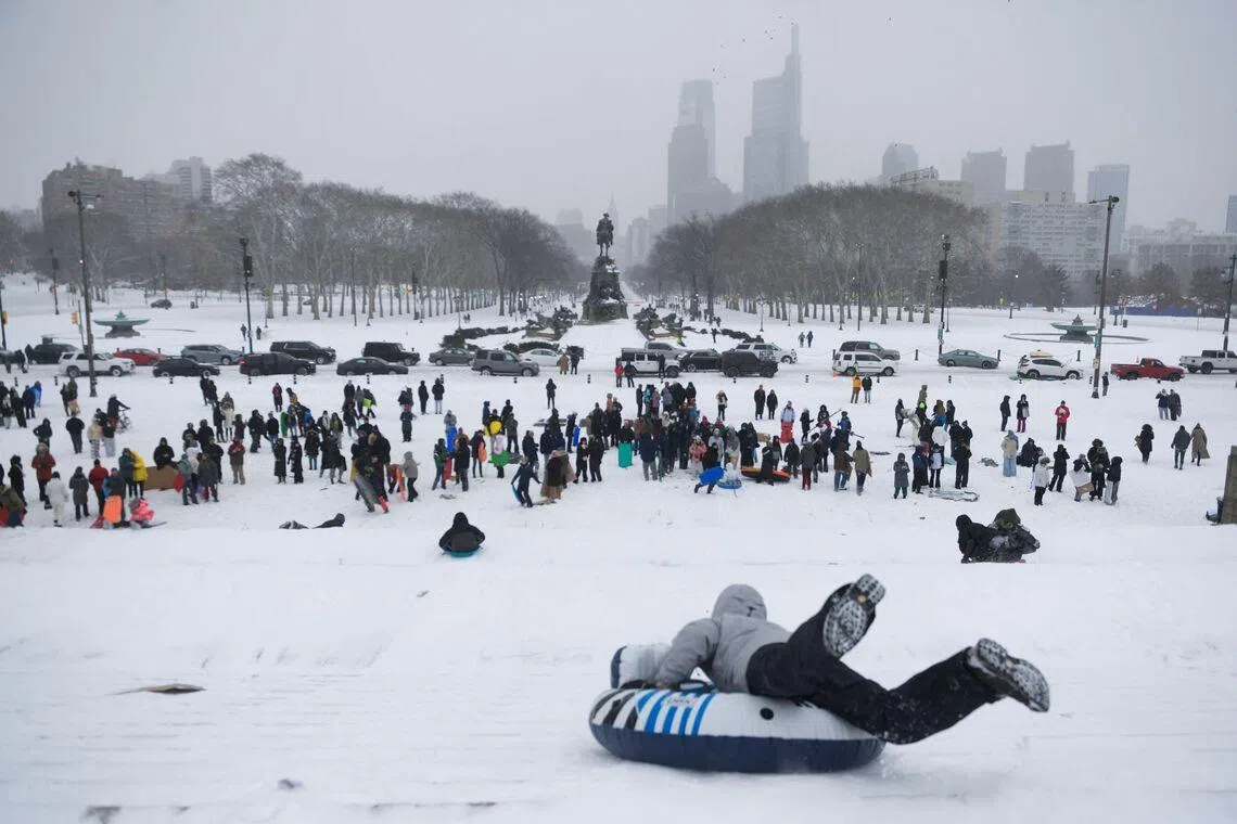 Philadelphia residents gather and sled down the steps of the Philadelphia Art Museum during a heavy snowfall in Philadelphia, Pennsylvania, on Jan 25, 2026. 
