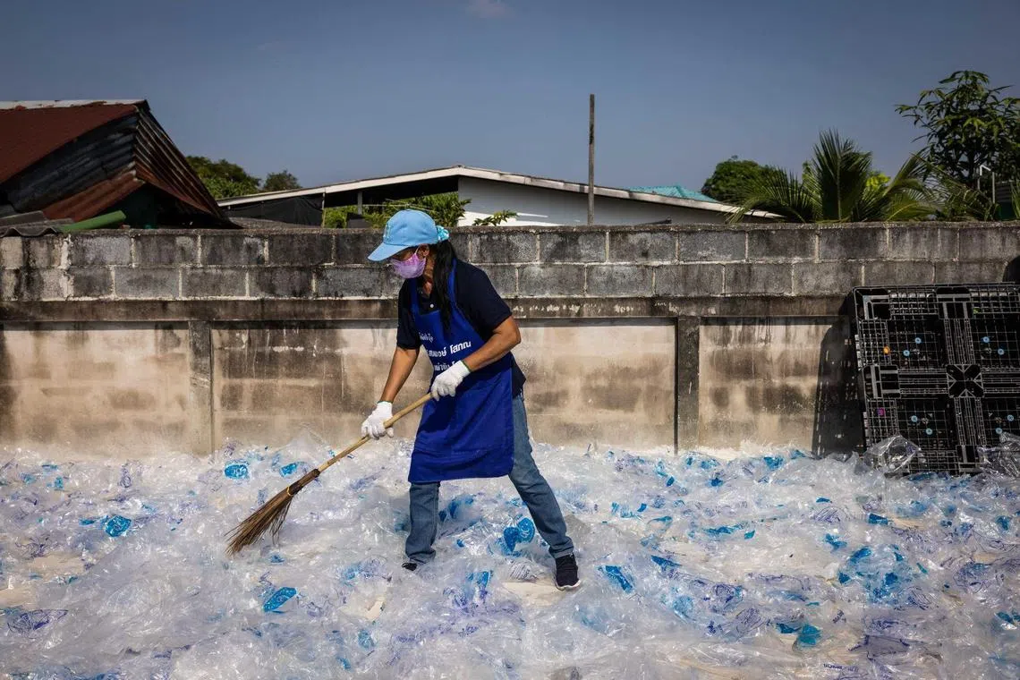 Volunteers spread plastic bags out to dry at a recycling center in Rayong, Thailand, on Wednesday, Dec. 14, 2022. Global plastic waste has more than doubled over the past two decades to 353 million metric tons annually, a number that the Organisation for Economic Co-operation and Development expects to almost triple by 2060. 