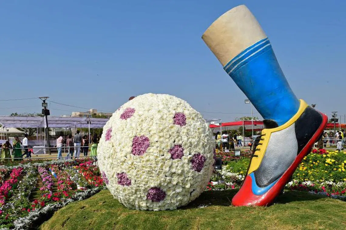 Visitors look at a flower installation during the 10th edition of Ahmedabad Flower Show at Sabarmati river front in Ahmedabad on January 1, 2023. PHOTO : AFP