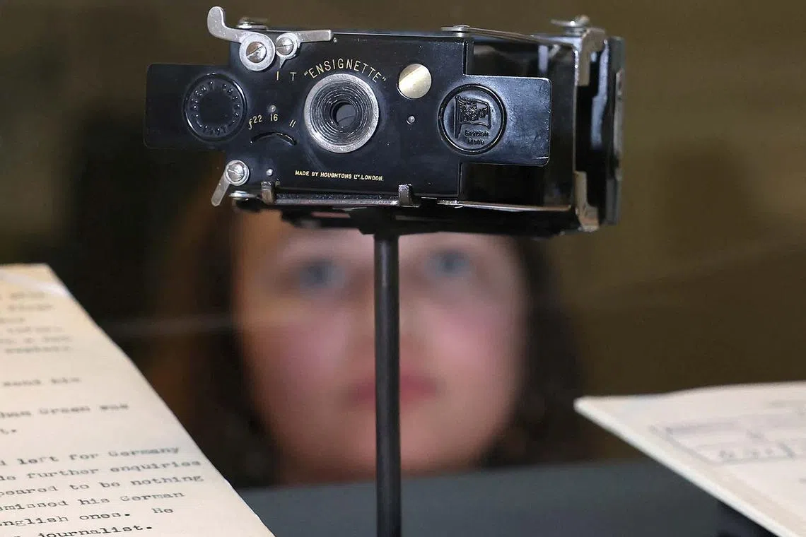 An employee viewing the first camera used by MI5 for spying, dated from 1910, which forms part of the MI5: Official Secrets exhibition exploring the history of the British intelligence agency, at The National Archives in London, Britain, April 1, 2025. 