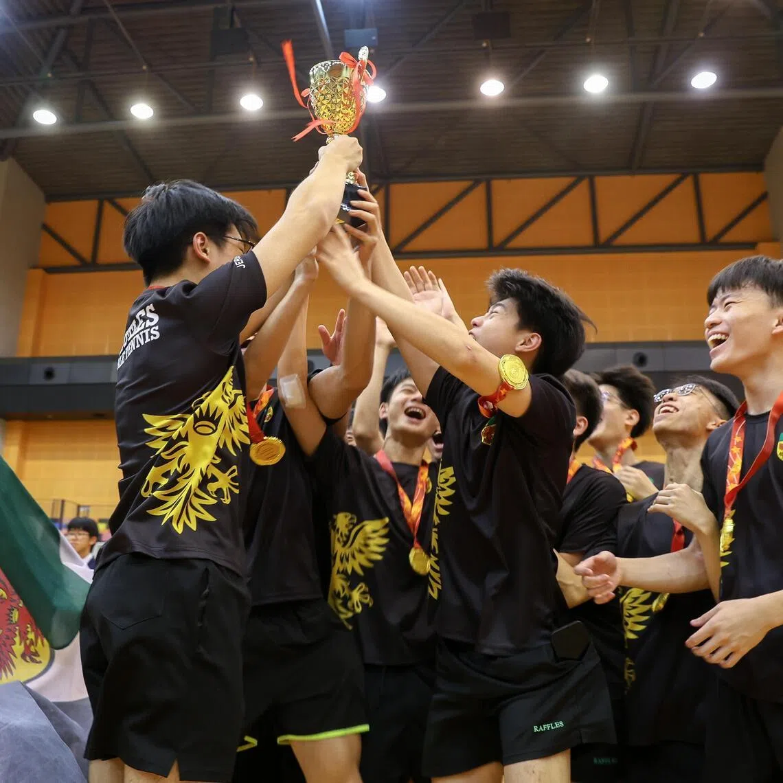 Players from Raffles Institution celebrating after receiving their gold medals and trophy for winning the National School Games A Division boys’ table tennis final. 
