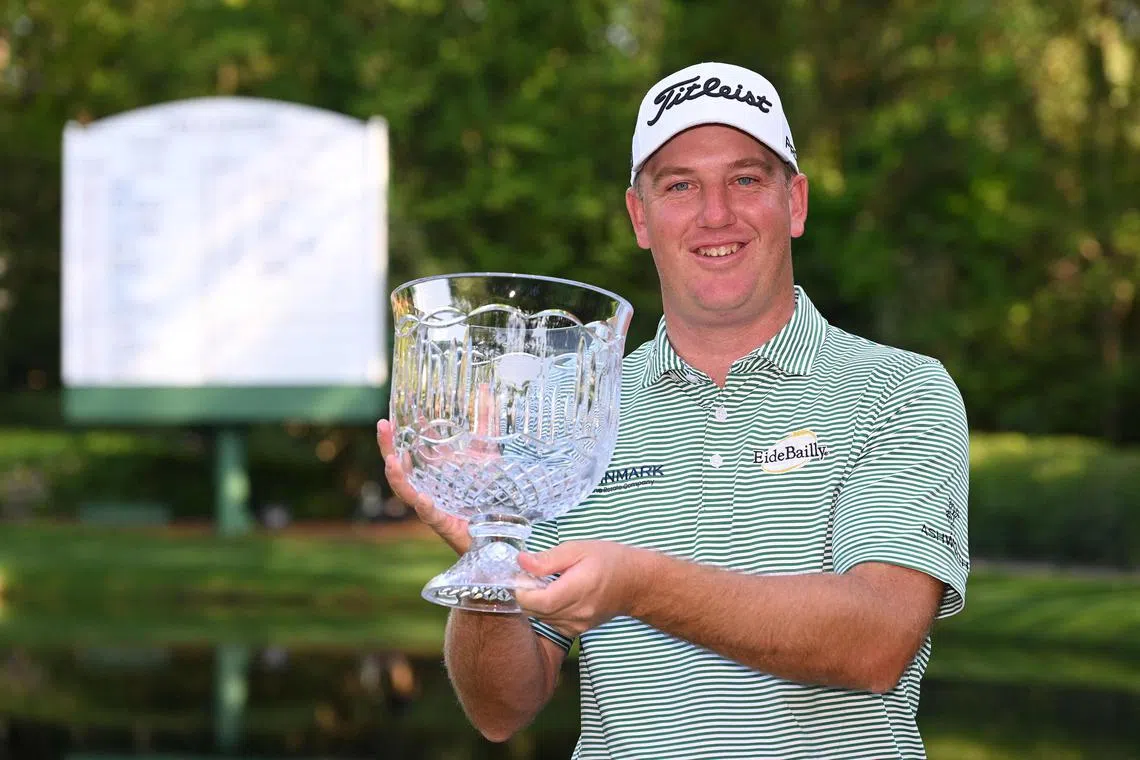 Tom Hoge posing with the Par-3 Contest trophy at the Masters in Augusta.