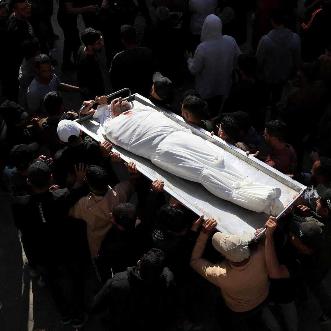 Mourners attending the funeral of Palestinians who were killed today in an Israeli strike, according to medics, at Al-Shifa Hospital in Gaza City, April 28, 2026. 