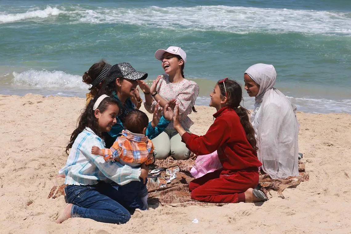 Displaced Palestinian girls playing at the beach in southern Gaza's Rafah on April 11, 2024, amid the ongoing conflict between Israel and the Palestinian Hamas militant group.