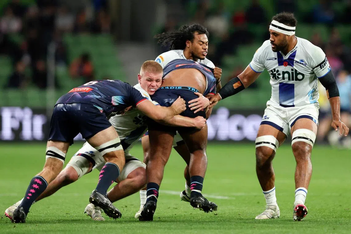 Auckland Blues' Anton Segner tackling Melbourne Rebels' Taniela Tupou in their Super Rugby match in Melbourne on May 3, 2024.